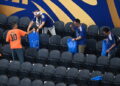 Japan fans clean up the stadium after the World Cup match against the Netherlands
