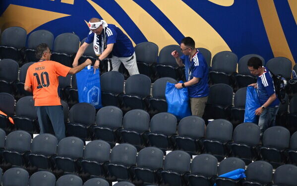 Japan fans clean up the stadium after the World Cup match against the Netherlands